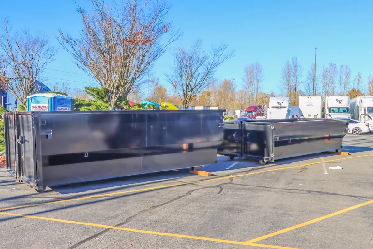 Professional dumpster rental service with roll-off container on residential driveway in Lower Saucon